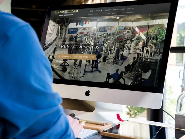 The Trojan Fitness website on a computer and a phone